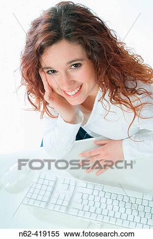 Secretary relaxed and smiling in the office, photographed from the front with her keyboard and mouse View Large Photo Image Stock Photography - Secretary relaxed and smiling in the office, photographed from the front with her keyboard and mouse. Fotosearch