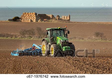 Seed drilling at Cley Norfolk in Spring and off shore windfarm. View Large Photo Image Stock Image - Seed drilling at Cley Norfolk in Spring and off shore windfarm.. Fotosearch