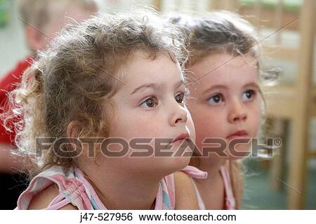 Stock Photograph - selective focus, Headshot, 2 little girls together. Fotosearch