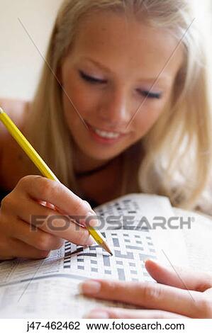 selective focus on a hand holding a pencil doing a crossword View Large Photo Image Stock Image - selective focus on a hand holding a pencil doing a crossword. Fotosearch