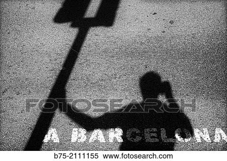 Self Portrait. Shadow of a photographer leaning against a traffic light photographing: A Barcelona. Barcelona, Espaa, Europa View Large Photo Image Stock Photography - Self Portrait. Shadow of a photographer leaning against a traffic light photographing: A Barcelona. Barcelona, Espaa, Europa. Fotosearch