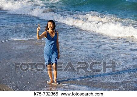 Self portrait with camera phone at beach View Large Photo Image Stock Photography - Self portrait with camera phone at beach. Fotosearch