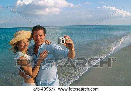 Stock Photo - self-portrait with digital camera. Fotosearch