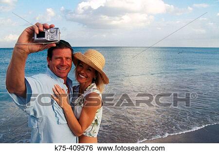 Stock Photograph - self-portrait with digital camera. Fotosearch