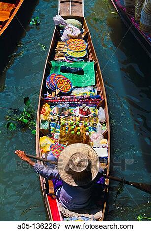 Seller in the Damnoen Saduak floating market, 100 km away from Bangkok Thailand. View Large Photo Image Stock Photo - Seller in the Damnoen Saduak floating market, 100 km away from Bangkok Thailand.. Fotosearch