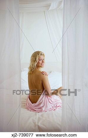 Semi-dress woman on the bed View Large Photo Image Stock Photo - Semi-dress woman on the bed. Fotosearch