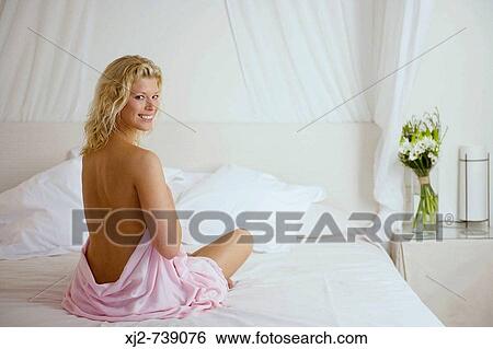 Semi-dress woman on the bed View Large Photo Image Stock Photograph - Semi-dress woman on the bed. Fotosearch