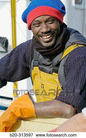 Stock Photo - Senegalese fishermen at port. Getaria. Guipzcoa, Spain. Fotosearch