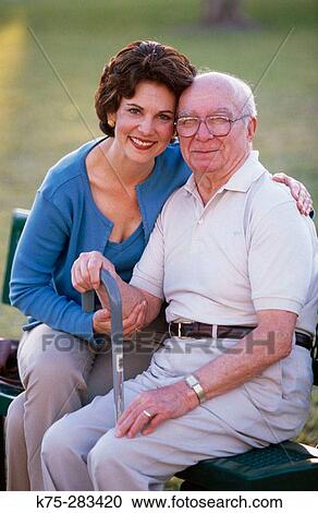 Stock Image - Senior and his daughter at the park. Fotosearch