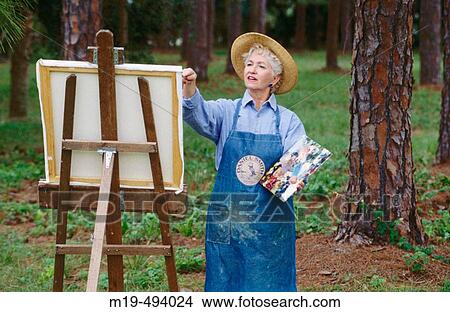 Picture - senior artist painting. Fotosearch