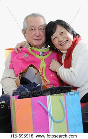 Senior asian couple having fun shopping View Large Photo Image Stock Photo - Senior asian couple having fun shopping. Fotosearch