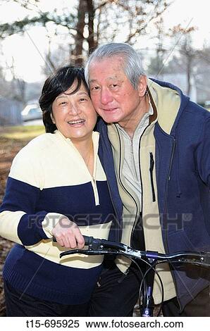 Senior asian couple having fun together on the bike outdoor View Large Photo Image Stock Photography - Senior asian couple having fun together on the bike outdoor. Fotosearch