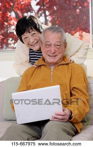 Senior Asian couple looking at camera and smiling View Large Photo Image Stock Photography - Senior Asian couple looking at camera and smiling. Fotosearch