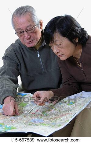 Senior asian couple planning a trip View Large Photo Image Stock Photo - Senior asian couple planning a trip. Fotosearch