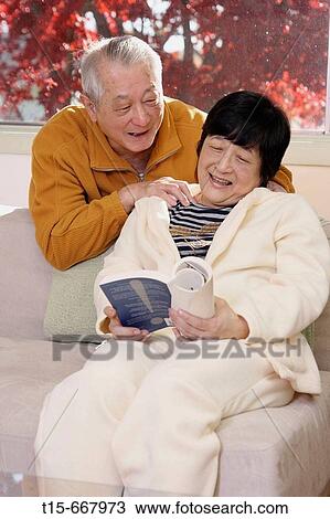 Senior Asian man giving his wife a massage while she reads View Large Photo Image Stock Image - Senior Asian man giving his wife a massage while she reads. Fotosearch
