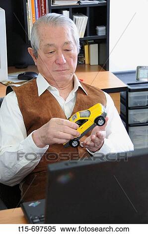 Senior asian man play with toy car View Large Photo Image Stock Photography - Senior asian man play with toy car. Fotosearch