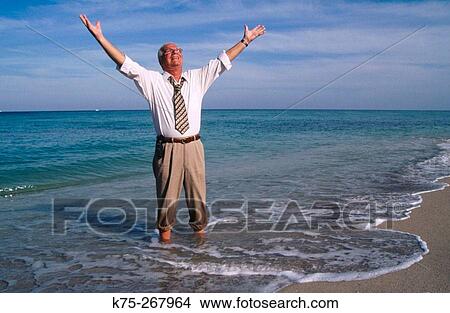 Senior businessman happy to be at the sea View Large Photo Image Picture - Senior businessman happy to be at the sea. Fotosearch