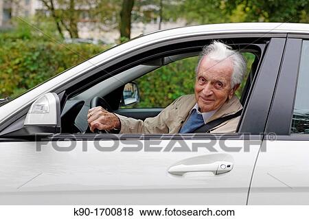 Senior caucasian man driving a white car and looking out of the window, Hamburg, Germany, Europe View Large Photo Image Stock Photo - Senior caucasian man driving a white car and looking out of the window, Hamburg, Germany, Europe. Fotosearch