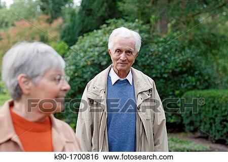 Senior caucasian man looking at senior woman with glasses, blurred green background, Hamburg, Germany, Europe View Large Photo Image Stock Photograph - Senior caucasian man looking at senior woman with glasses, blurred green background, Hamburg, Germany, Europe. Fotosearch