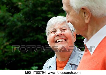 Senior caucasian woman, wearing glasses, looking and smiling at senior man, Hamburg, Germany, Europe View Large Photo Image Picture - Senior caucasian woman, wearing glasses, looking and smiling at senior man, Hamburg, Germany, Europe. Fotosearch