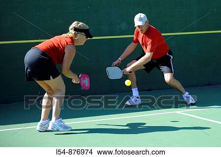 Senior citizens compete in game of Pickleball in the Senior state Olympics near Naples Florida View Large Photo Image Picture - Senior citizens compete in game of Pickleball in the Senior state Olympics near Naples Florida. Fotosearch