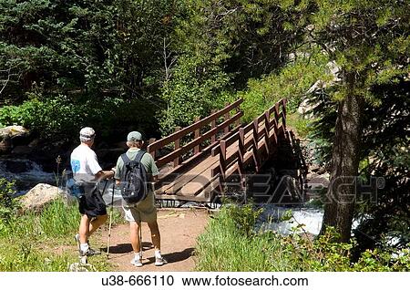 Stock Image - Senior citizens hiking in the Rocky Mountains, Colorado, USA. Fotosearch