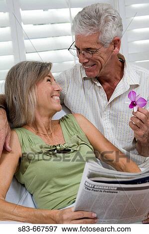 Senior couple being romantic with flower View Large Photo Image Stock Photo - Senior couple being romantic with flower. Fotosearch