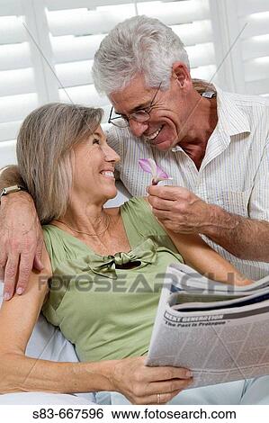 Stock Photograph - Senior couple being romantic with flower. Fotosearch