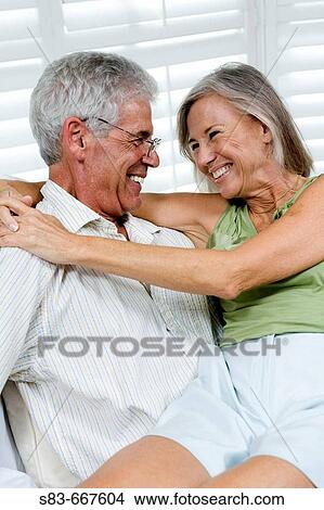 Senior couple being romantic. Woman sitting on mans lap. View Large Photo Image Picture - Senior couple being romantic. Woman sitting on mans lap.. Fotosearch