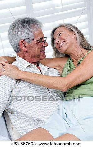 Senior couple being romantic. Woman sitting on mans lap. View Large Photo Image Stock Image - Senior couple being romantic. Woman sitting on mans lap.. Fotosearch