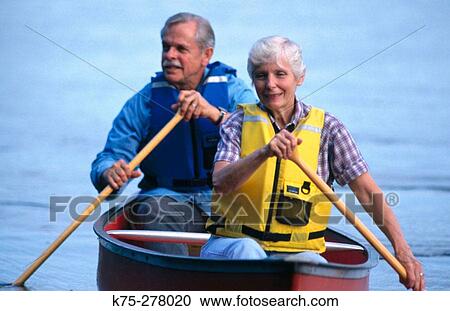 Senior couple canoeing with life vests View Large Photo Image Stock Image - Senior couple canoeing with life vests. Fotosearch