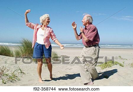 Picture - Senior couple dancing on the beach. Fotosearch