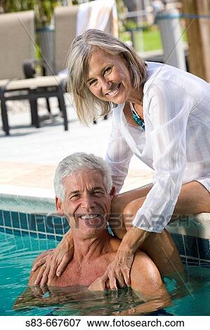 Senior couple enjoying swimming pool View Large Photo Image Stock Photo - Senior couple enjoying swimming pool. Fotosearch