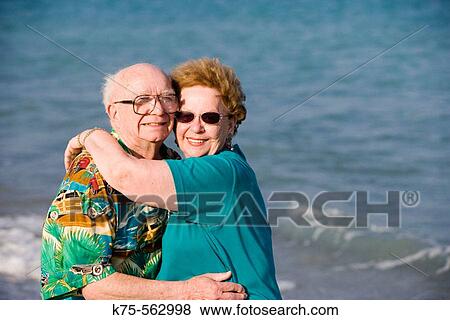 Senior couple hugging at the beach View Large Photo Image Stock Photo - Senior couple hugging at the beach. Fotosearch