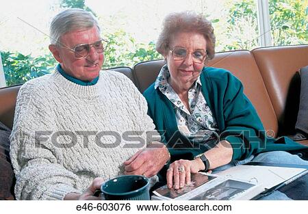 Senior couple looking at phot album View Large Photo Image Stock Photograph - Senior couple looking at phot album. Fotosearch
