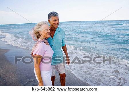 Senior couple looking out at the ocean View Large Photo Image Stock Image - Senior couple looking out at the ocean. Fotosearch