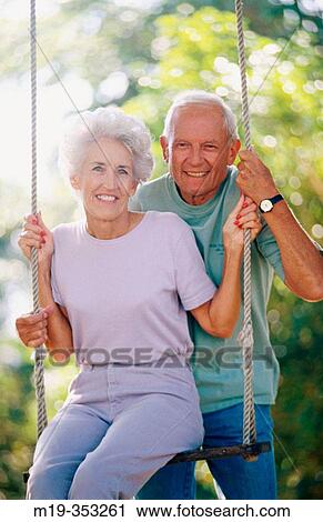 Stock Image - senior couple on a swing. Fotosearch