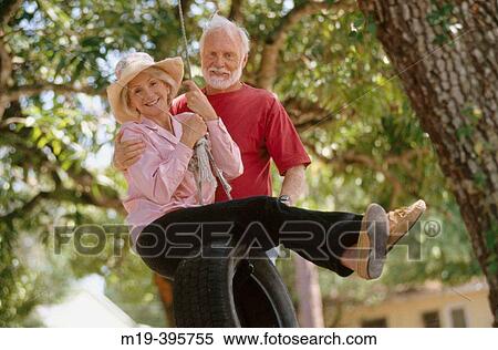 senior couple on a tire swing View Large Photo Image Stock Photography - senior couple on a tire swing. Fotosearch