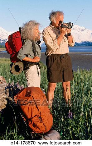 Senior couple videotaping. Chugach National Forest. Alaska. USA View Large Photo Image Stock Image - Senior couple videotaping. Chugach National Forest. Alaska. USA. Fotosearch