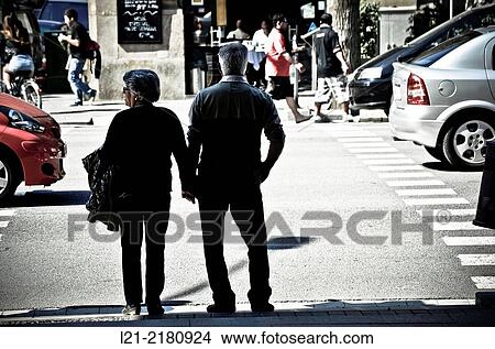 Senior couple waiting at a stoplight in a street. Barcelona, Catalonia, Spain. View Large Photo Image Picture - Senior couple waiting at a stoplight in a street. Barcelona, Catalonia, Spain.. Fotosearch