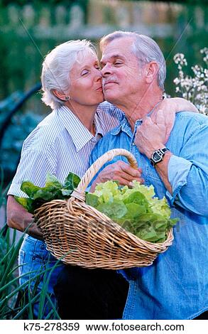 Stock Photo - Senior couple with basket of lettuce. Fotosearch