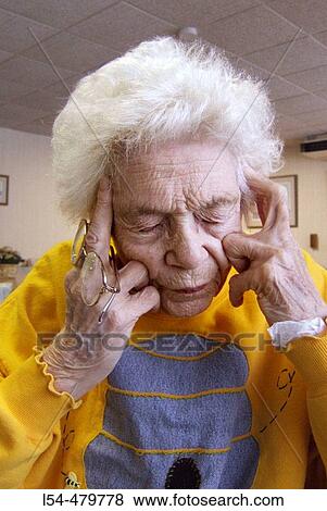 Stock Photo - Senior female has a bad headache. Fotosearch