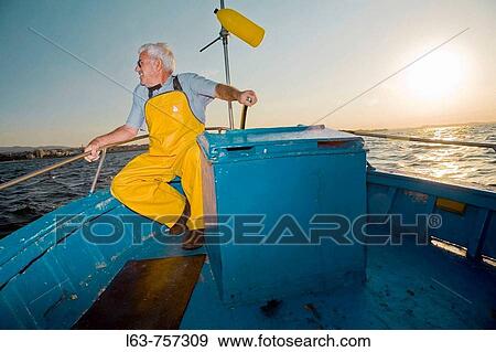 Senior fisherman in his boat, Cambrils. Tarragona province, Catalonia, Spain View Large Photo Image Stock Photo - Senior fisherman in his boat, Cambrils. Tarragona province, Catalonia, Spain. Fotosearch