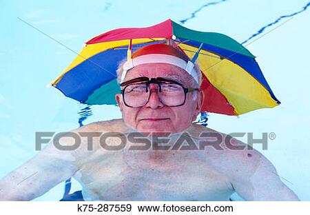 senior in pool with umbrella hat View Large Photo Image Stock Photo - senior in pool with umbrella hat. Fotosearch