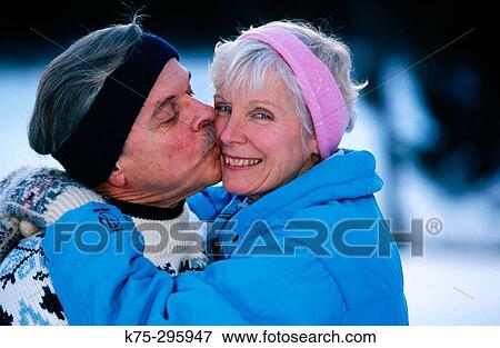 Senior kisses his wife outdoors in winter View Large Photo Image Stock Photo - Senior kisses his wife outdoors in winter. Fotosearch