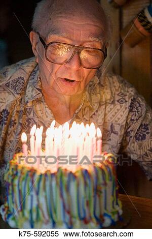 Stock Photography - Senior, male, caucasian, age 87, candles, birthday cake, celebration. Fotosearch