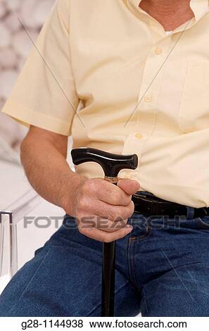 senior man hand holding a walking stick View Large Photo Image Stock Photo - senior man hand holding a walking stick. Fotosearch