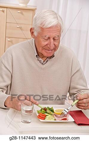 senior man having his meal View Large Photo Image Stock Image - senior man having his meal. Fotosearch