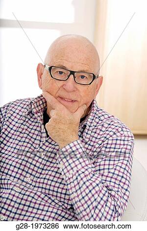 Stock Photograph - Senior Man head in chin wearing spectacles, thoughtful mood. Fotosearch