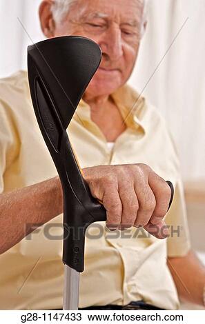 senior man holding his crutches View Large Photo Image Stock Image - senior man holding his crutches. Fotosearch